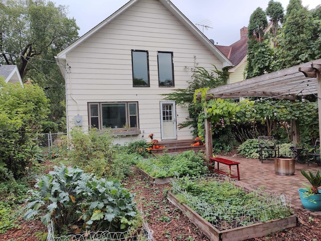 back of house with a pergola and a patio