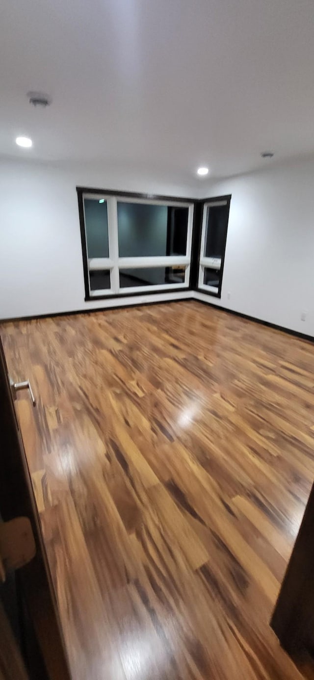 empty room with hardwood / wood-style flooring