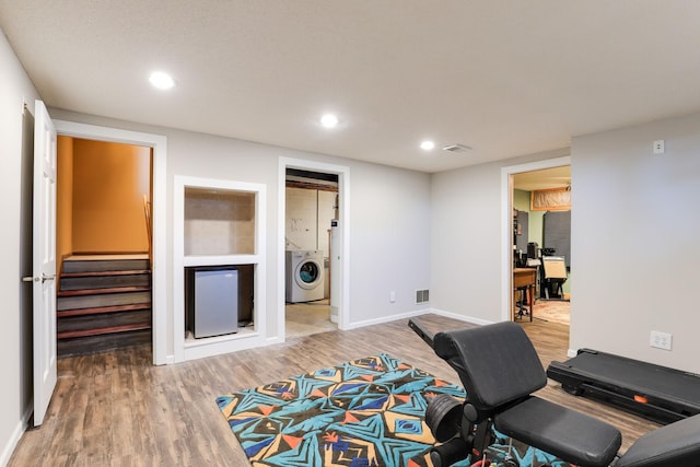 home office featuring hardwood / wood-style floors and washer / dryer