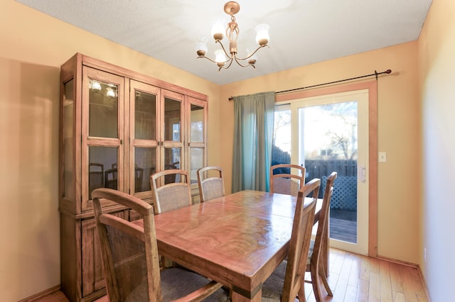 dining room featuring hardwood / wood-style flooring and a notable chandelier