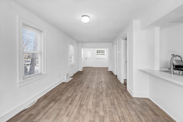 hall with hardwood / wood-style floors