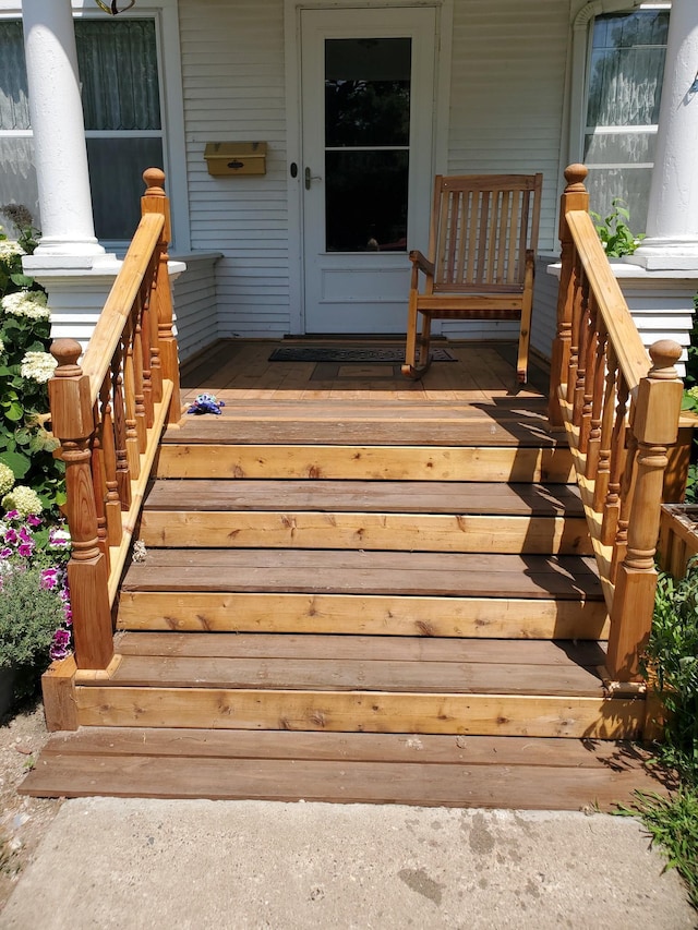 view of exterior entry featuring covered porch