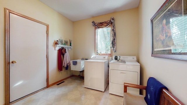 laundry area with sink and washer and clothes dryer