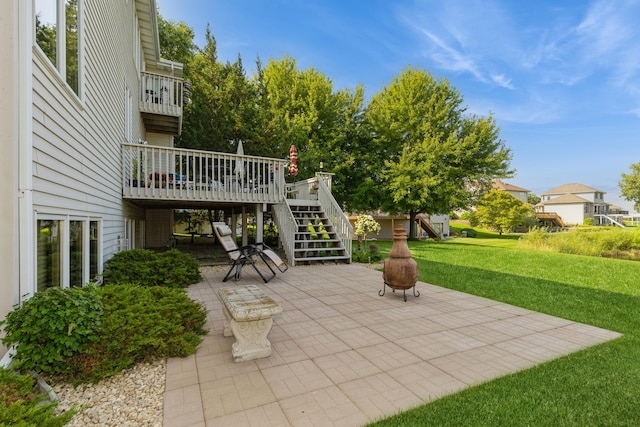 view of patio with a wooden deck and a fire pit