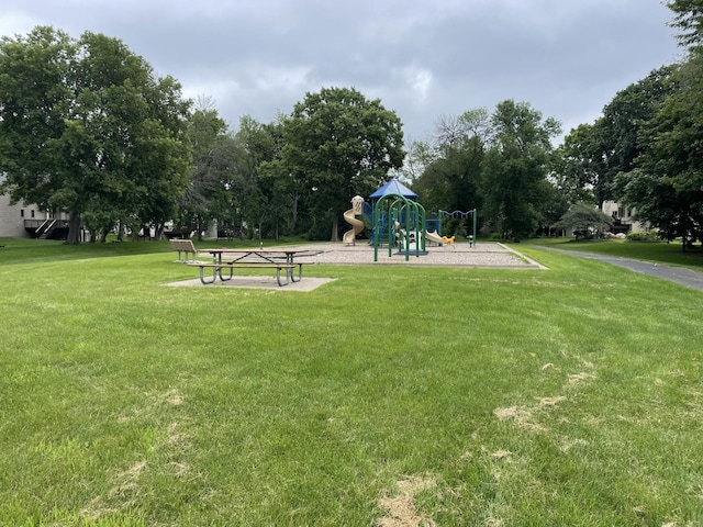 view of property's community featuring a playground and a yard