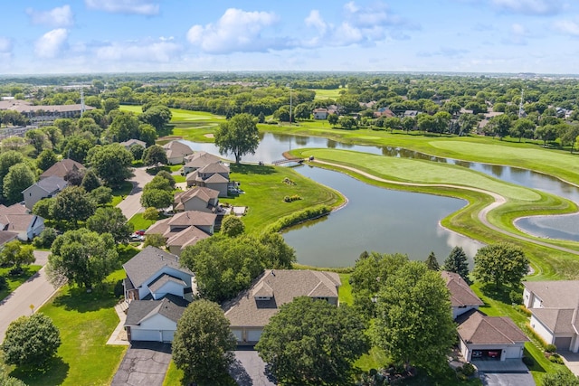 drone / aerial view with a residential view, golf course view, and a water view