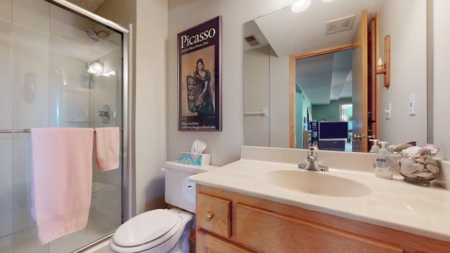 bathroom featuring vanity, a shower stall, toilet, and visible vents