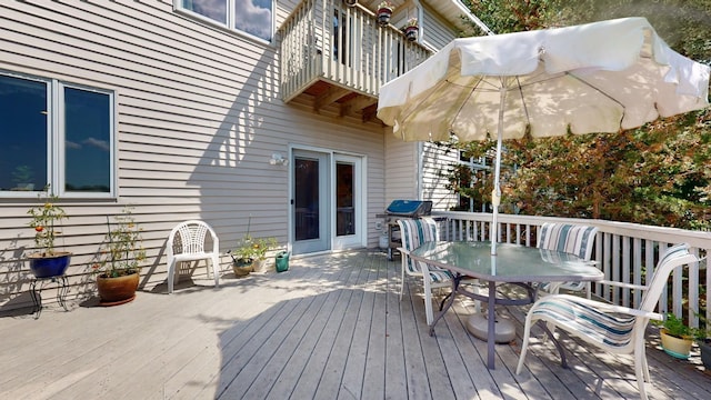 deck featuring grilling area and outdoor dining space