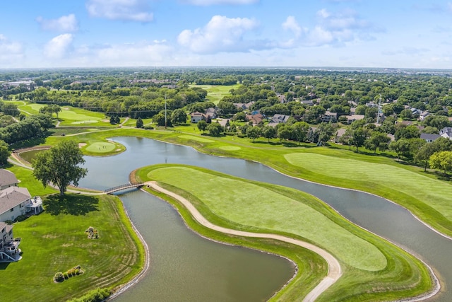 birds eye view of property with golf course view and a water view