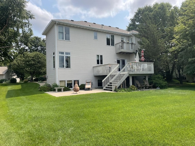 back of property with a yard, a deck, stairs, and a patio area