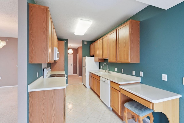 kitchen with a textured ceiling, white appliances, sink, light tile patterned floors, and a notable chandelier