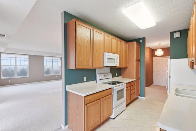 kitchen with pendant lighting, white appliances, light colored carpet, and an inviting chandelier