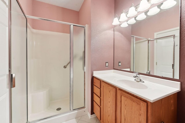 bathroom with tile patterned floors, vanity, and a shower with shower door