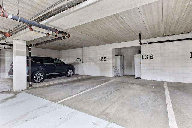 garage with water heater and a carport