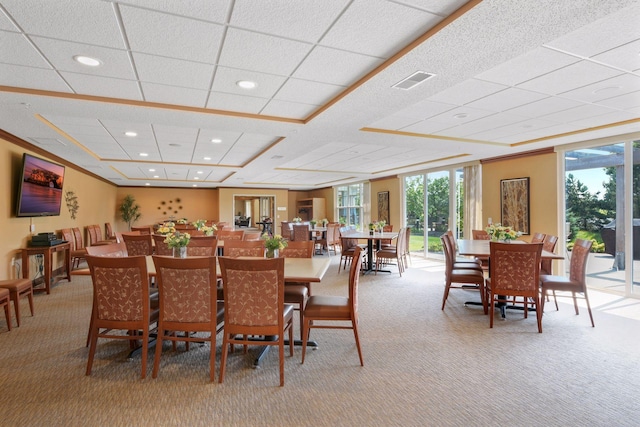 carpeted dining area with crown molding