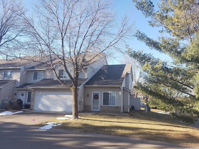 view of front of property with a garage and a front yard