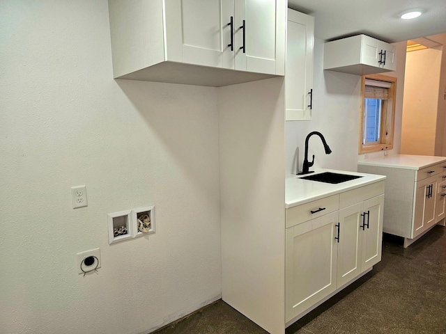 washroom featuring cabinets, sink, and hookup for a washing machine