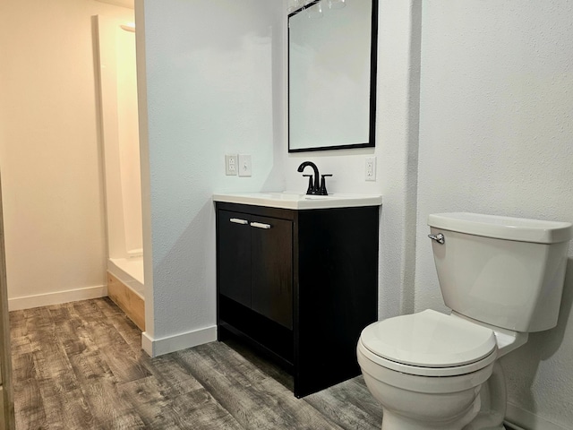 bathroom featuring hardwood / wood-style floors, toilet, and vanity