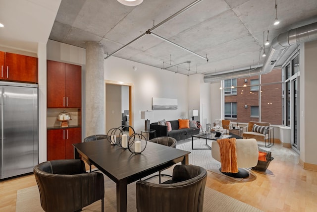 dining space featuring light hardwood / wood-style floors and rail lighting