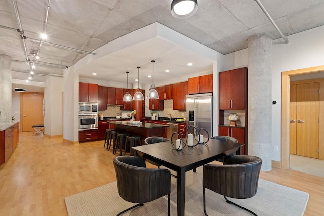 dining room with sink and light hardwood / wood-style flooring