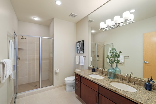 bathroom with vanity, tile patterned floors, toilet, and walk in shower