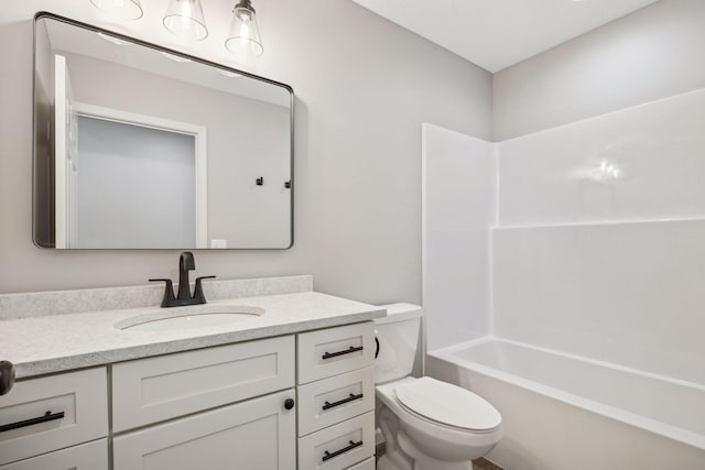 full bathroom with washtub / shower combination, vanity, and toilet