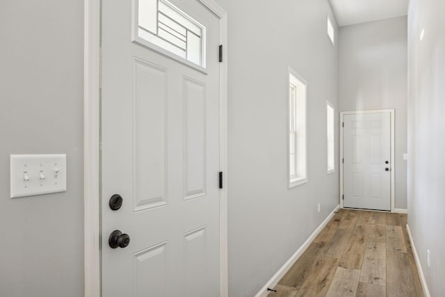 doorway to outside with light wood-type flooring and plenty of natural light