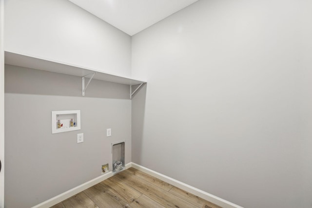 laundry room with hookup for a washing machine and light hardwood / wood-style flooring