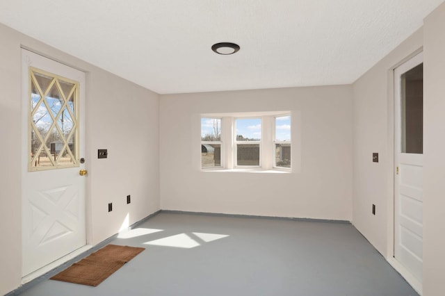 entryway featuring finished concrete floors and a textured ceiling