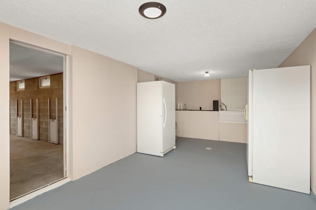 empty room featuring finished concrete floors and a textured ceiling