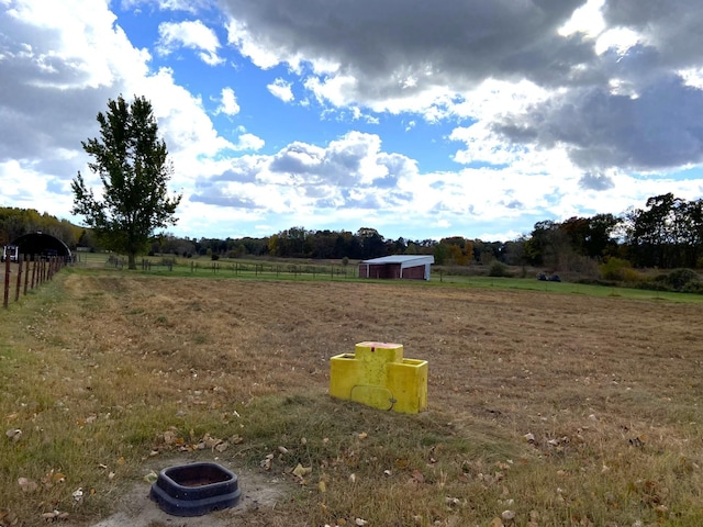 view of yard with a rural view and fence