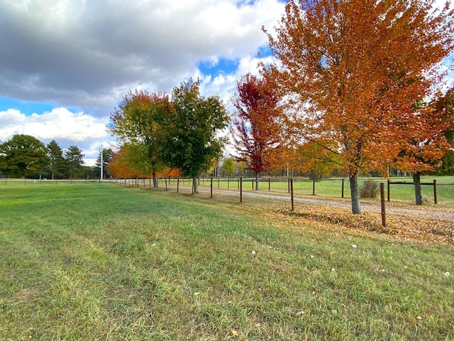 view of yard with a rural view and fence