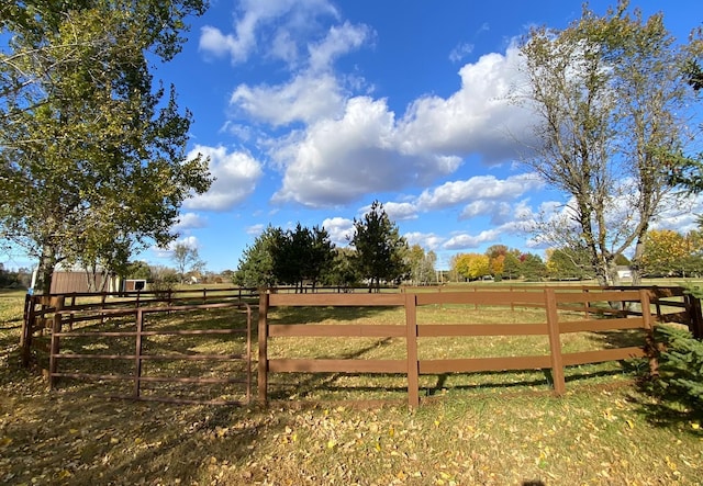 view of yard featuring a rural view and fence