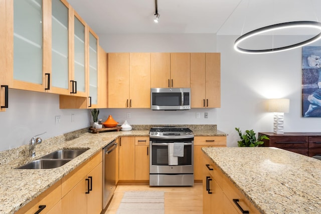 kitchen featuring sink, light brown cabinets, light stone counters, and stainless steel appliances