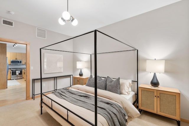 bedroom with light carpet and a notable chandelier