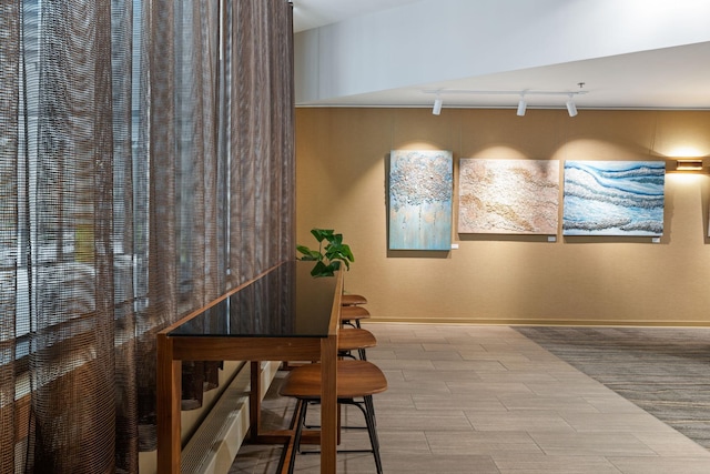 dining space featuring rail lighting