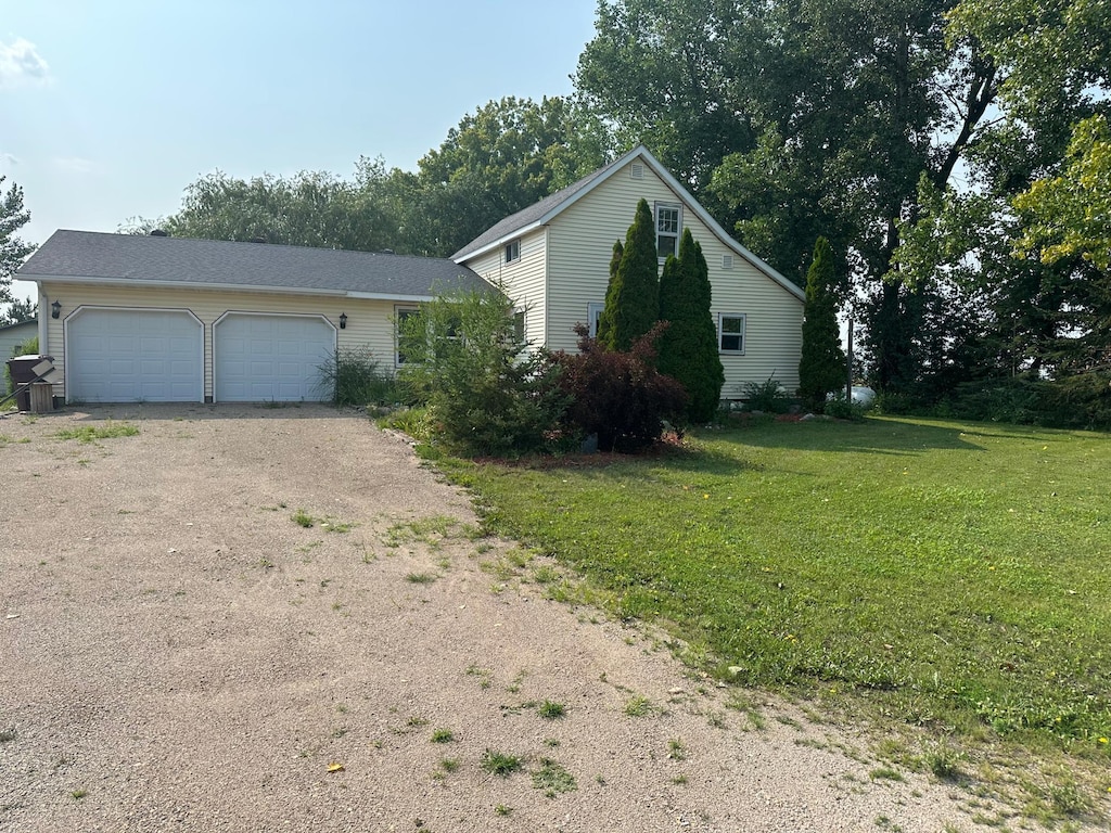 view of front of property featuring a garage and a front yard