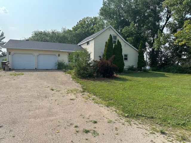 view of front of property featuring a garage and a front yard