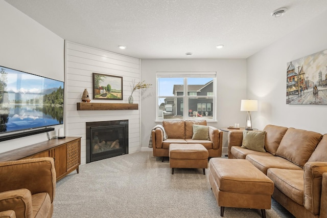 living room featuring a textured ceiling and a fireplace