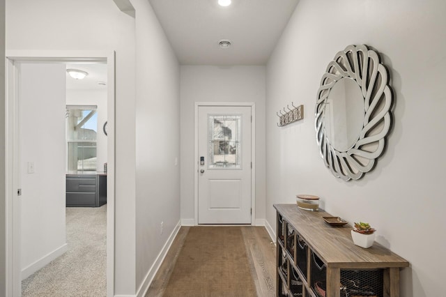 doorway to outside with carpet floors