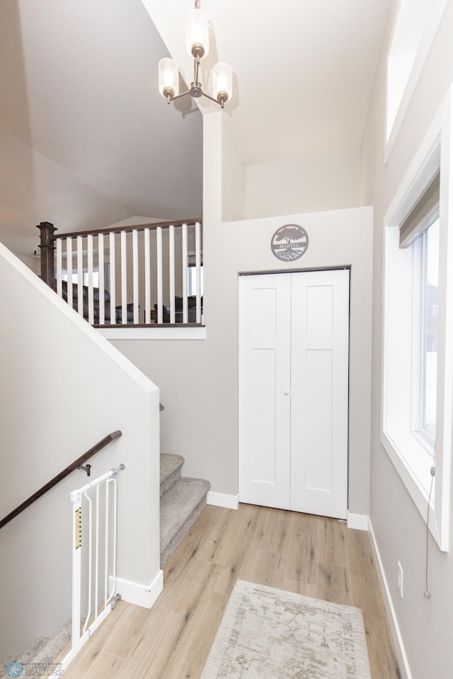 entrance foyer with light hardwood / wood-style flooring and a chandelier