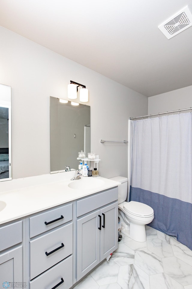 bathroom with vanity, curtained shower, and toilet