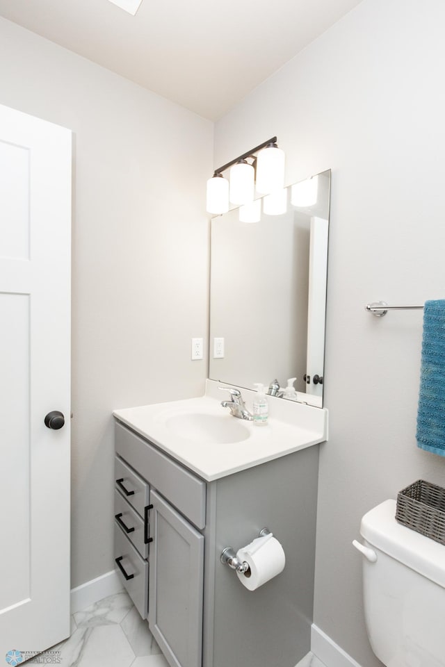 bathroom featuring vanity and toilet