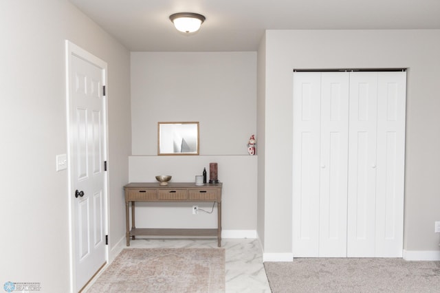 hallway featuring light colored carpet