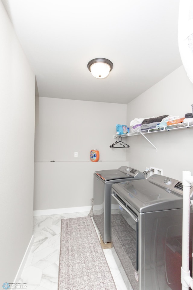 clothes washing area with separate washer and dryer