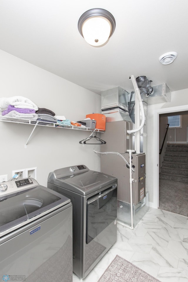 clothes washing area featuring independent washer and dryer