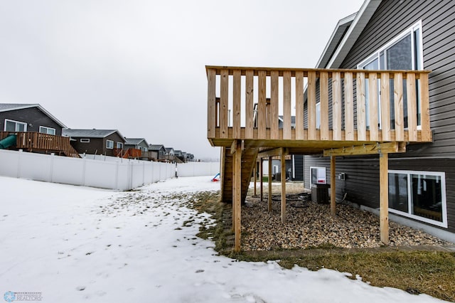 snowy yard with a wooden deck