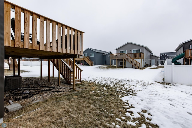 snowy yard with a deck