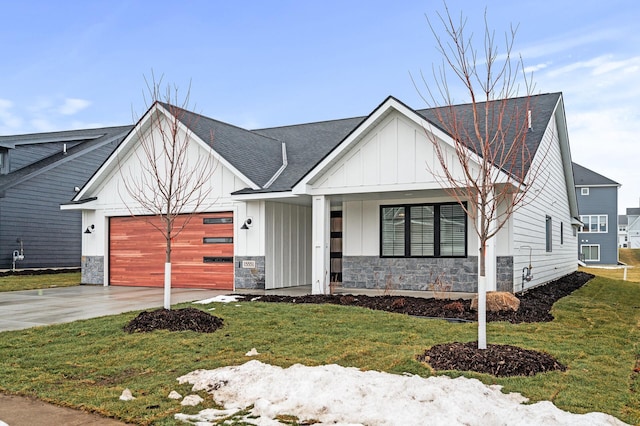 modern farmhouse style home with a front yard, a porch, and a garage