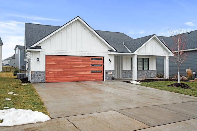 modern farmhouse featuring a front yard, a garage, and central air condition unit